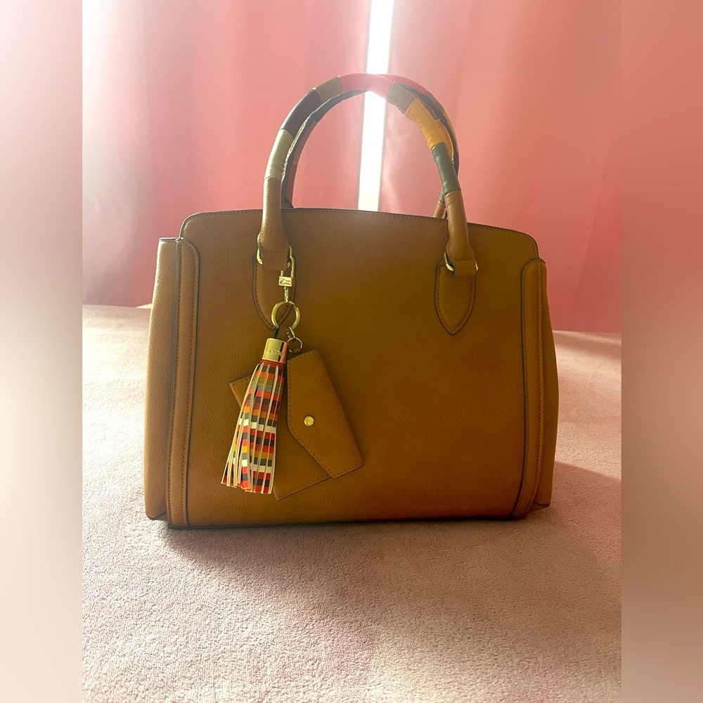 Aldo large tote bag is mainly tan with an orange red interior.